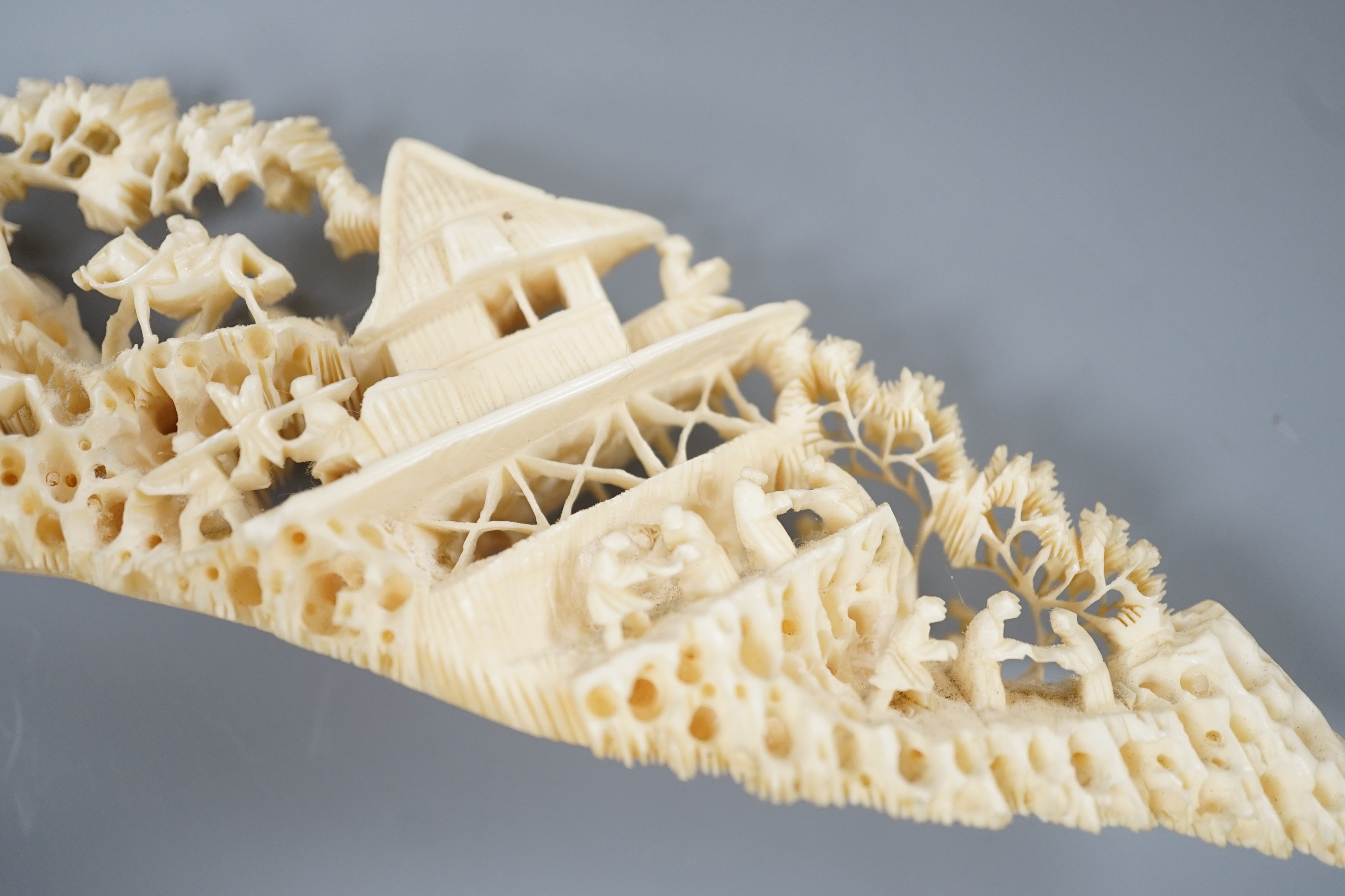 An early 20th century Chinese ivory ‘dragon’ box and cover, and a boar’s tusk carving of figures amid pavilions 40cm
